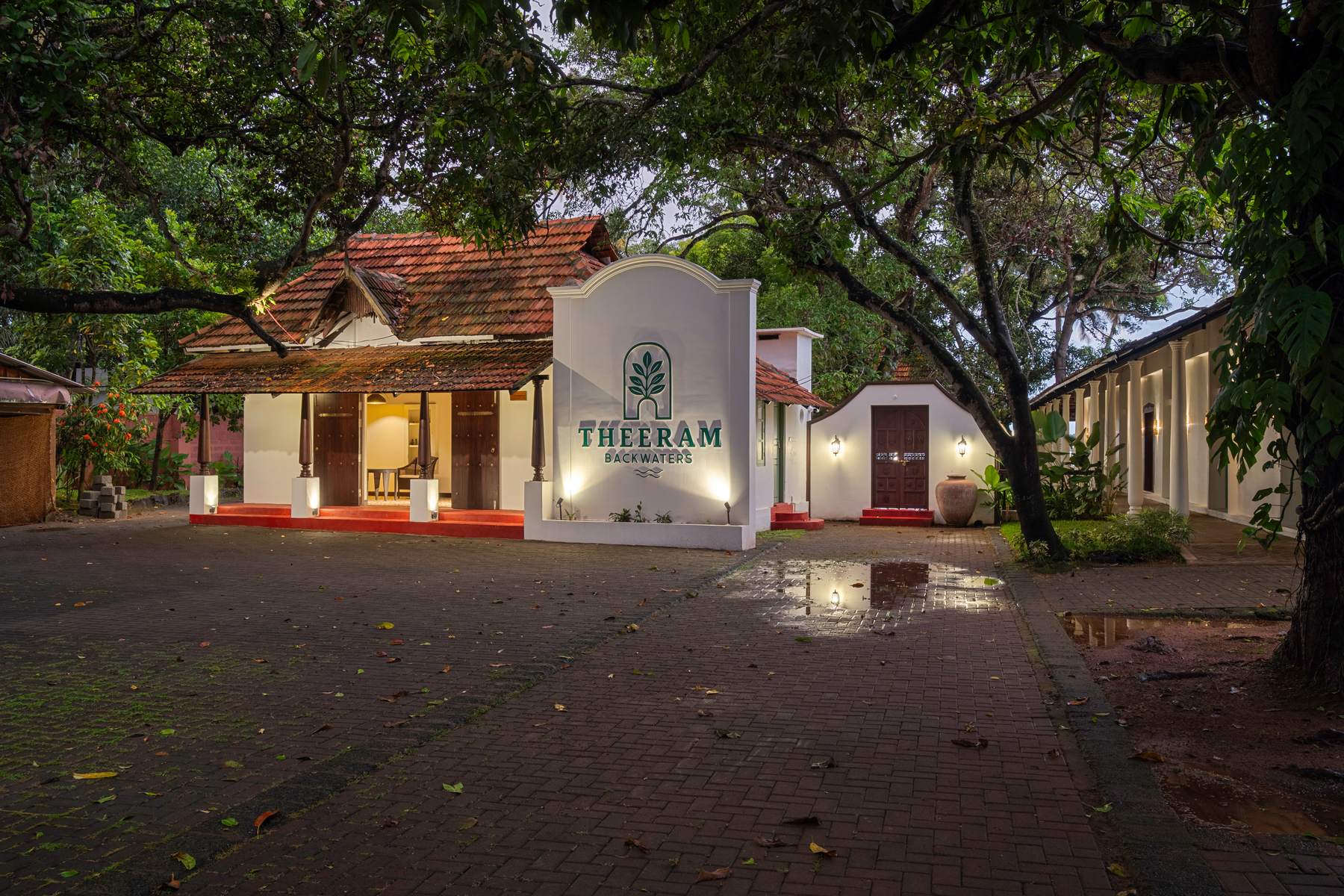Theeram Backwaters entrance, lit at dusk