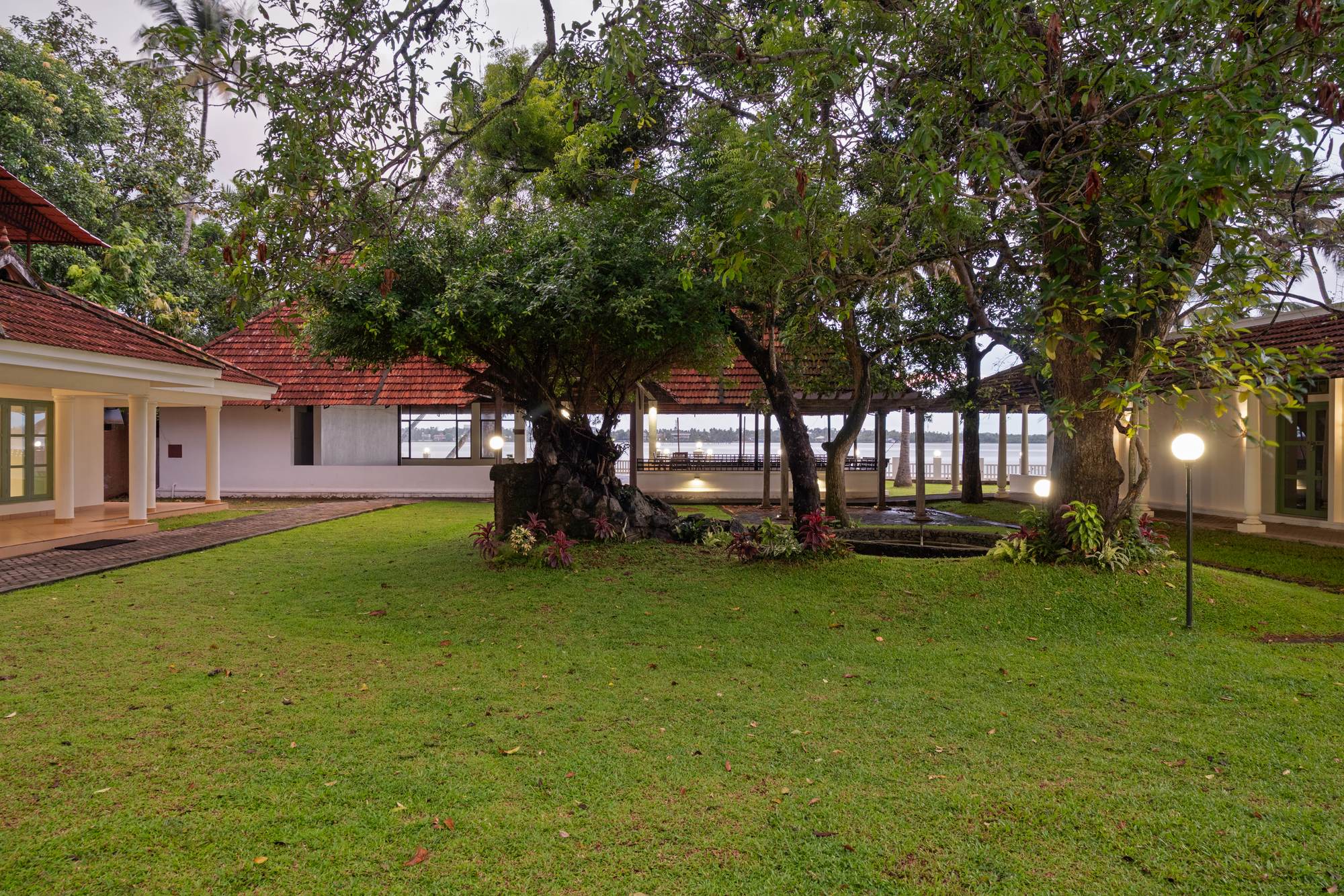 A hammock strung between trees on the lawn at Theeram, with the backwaters beyond